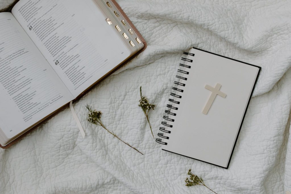 A Book and a Notebook on the White Textile