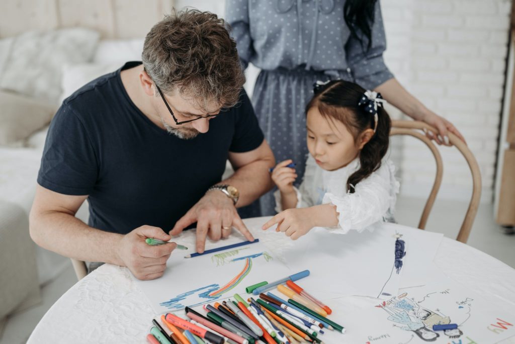 A Man Making a Drawing on a White Paper