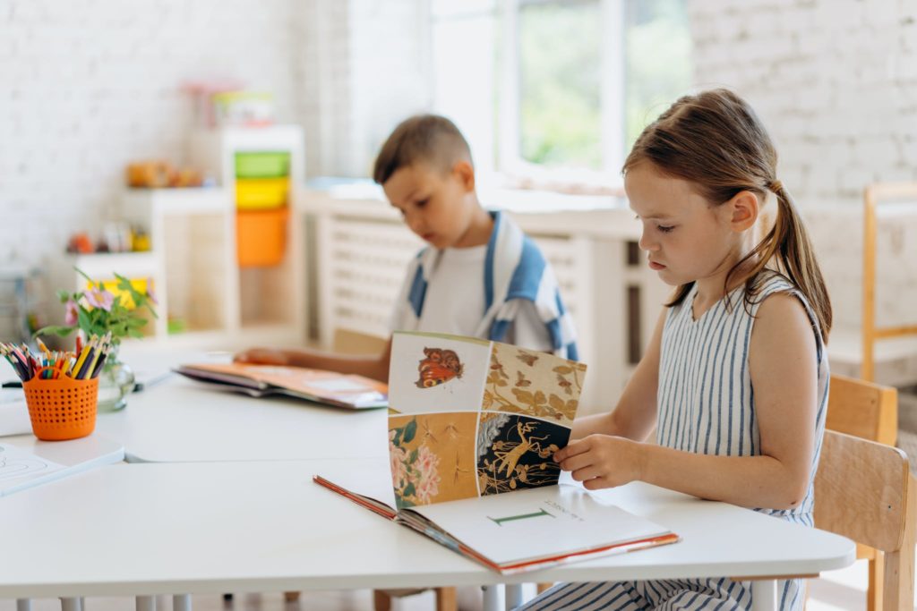 Kids Sitting Looking at the Books 