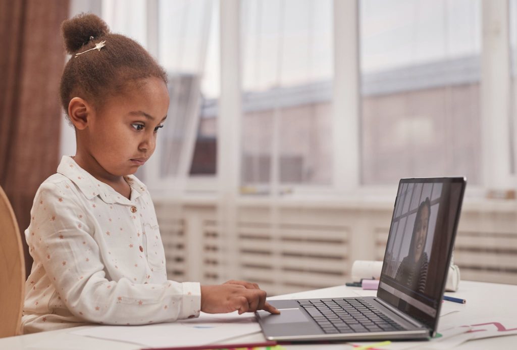 A Girl Using a Laptop at Home