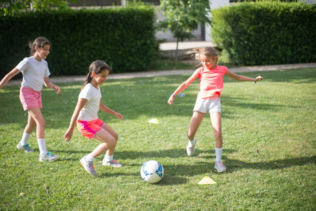 A Group of Girls Playing Football on the Field