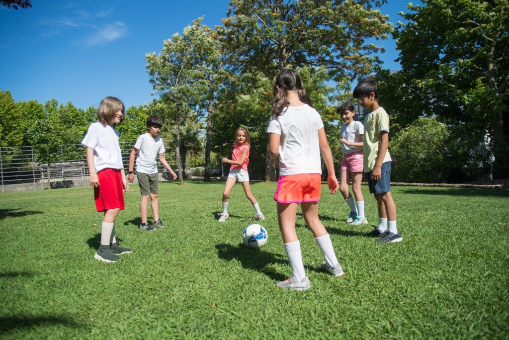 A Group of Kids Playing Football at the Field